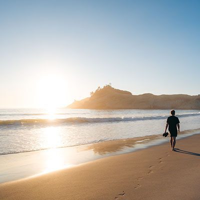 Man Walking on Pacific City Beach